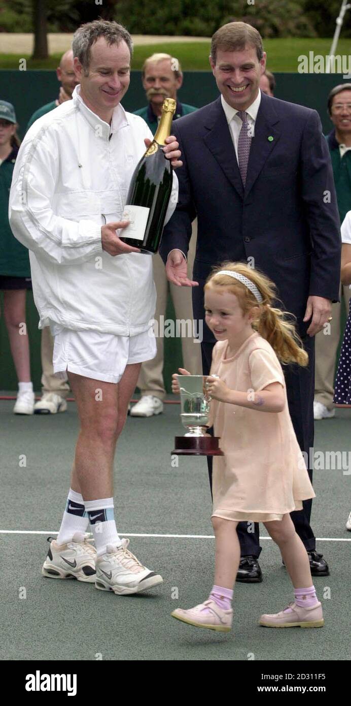 John McEnroe's daughter, four year old Anna McEnroe, walks off with her  father's trophy for winning a charty match against Bjorn Borg at Buckingham  Palace during the Duke of York's NSPCC Challenge,