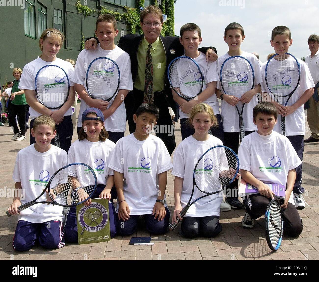 NO COMMERCIAL USE: Sir Cliff Richard meets a group of young tennis players at Wimbledon who are receiving coaching from his charity, the Cliff Richard Tennis Foundation. * This coincides with the launch of his 'Kids On Court' campaign aimed at giving all children the chance to try tennis. * Back row (left to right) : Maria Wisdom aged 13 from Portsmouth, Kevin Gissing 15 from Portsmouth, Sir Cliff Richard, Ben Frank 13 from Portsmouth, Matt Ward 13 from Portsmouth, Steven McKenzie 11 NO CPMMERCIAL USE: from Sterling. Front row (left to right): Robert Wood 13 from Redbridge, Francesca Jack Stock Photo