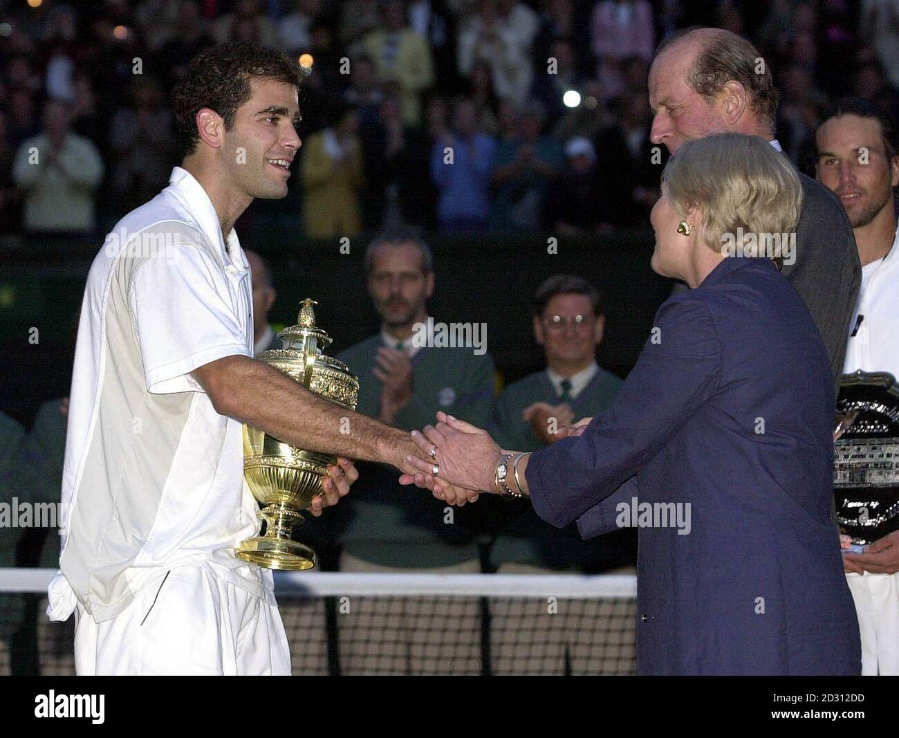 America's Pete Sampras receives the Men's Singles trophy from HRH Duke & Duchess of Kent after defeating Pat Rafter 6/7 7/6 6/4 6/2 to win the Men's Singles Final at Wimbledon. Stock Photo