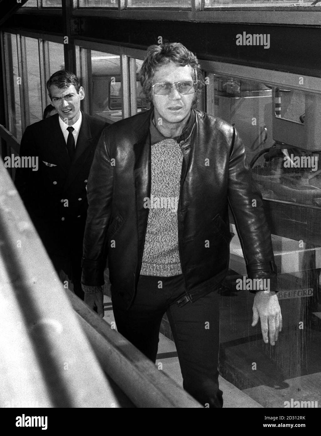 American actor and racing driver Steve McQueen (right) leaving Heathrow Airport in London, where he is heading to France to attempt to enter the Le Mans 24 hour sports car race. Stock Photo
