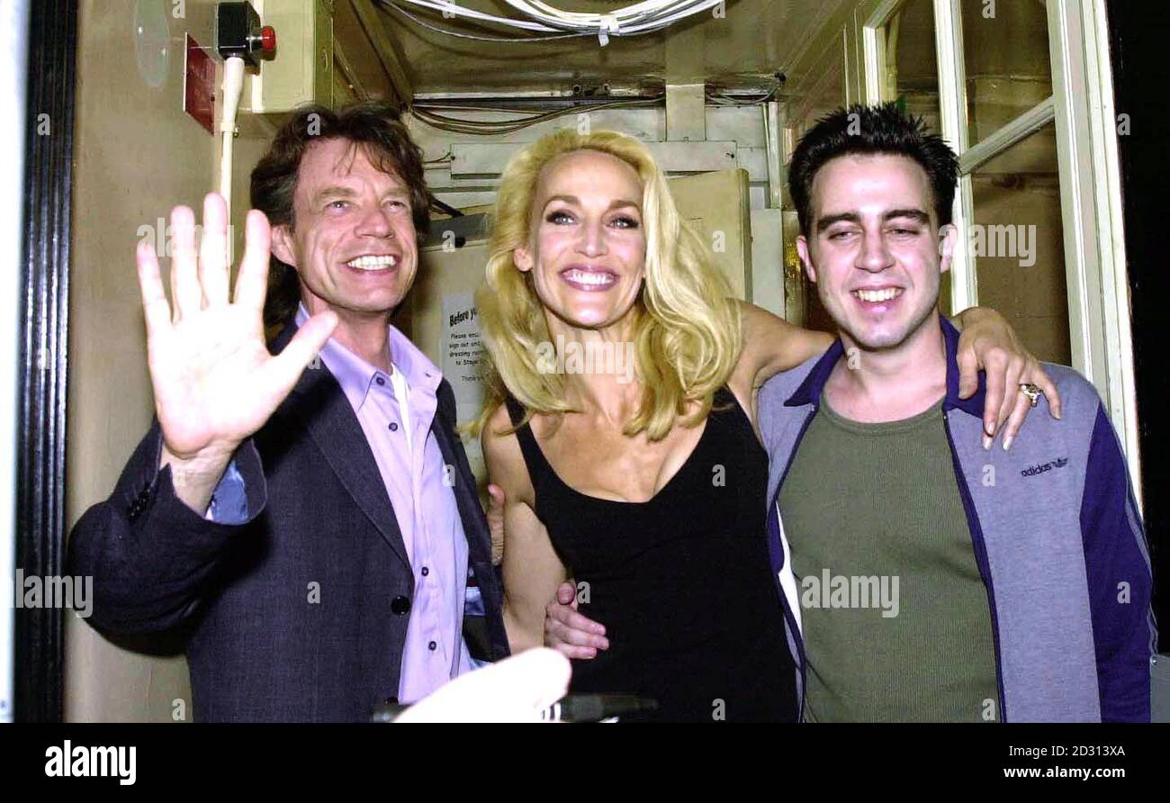 Former supermodel turned actress Jerry Hall with ex-husband Mick Jagger (L) and co-star Josh Cohen outside the Gielgud Theatre in London, following Hall's debut in the hit play The Graduate.    * ... In the play Jerry Hall plays middle-aged temptress Mrs Robinson who seduces the son of family friends.  Stock Photo