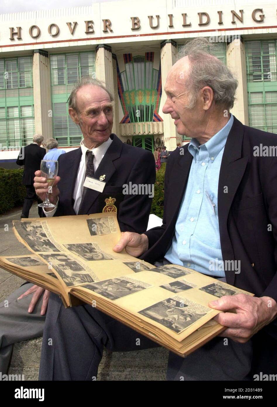 Charles Hardy (left) and Fred Tilsley go through old photographs outside  the Hoover Building in west. The pair were reunited today 60 years after  being evacuated to America together in 1940 to
