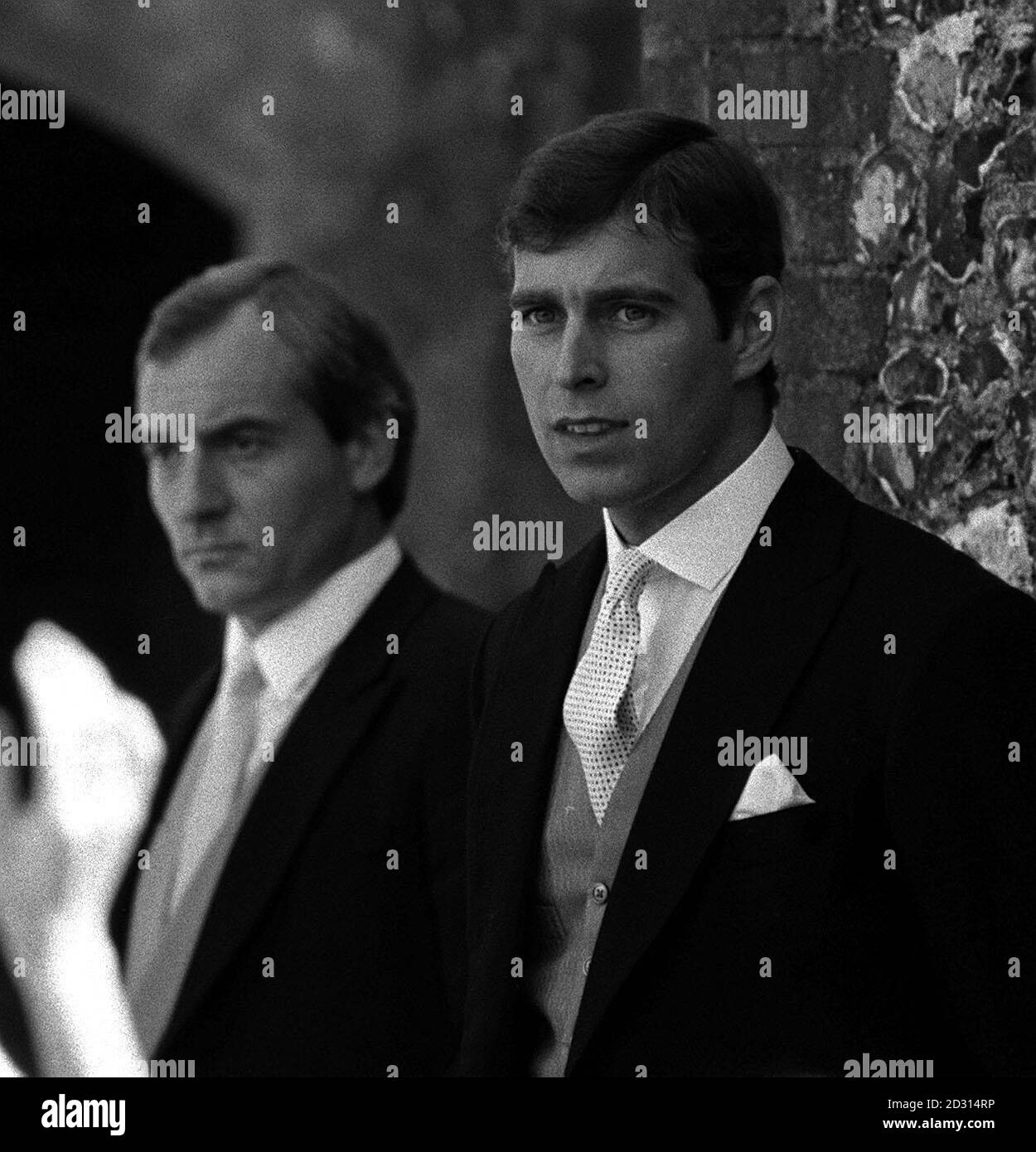 1985: Prince Andrew (right) at Highclere , Berkshire, where he was attending the wedding of the Hon. Carolyn Herbert to bloodstock agent John Warren. To the left is the Princess of Wales' police bodyguard, Barry Mannakee. Stock Photo