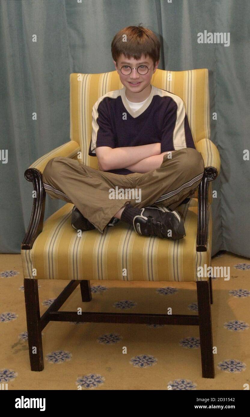 Actor Daniel Radcliffe (centre), who is to play Harry Potter in the film "Harry  Potter and the Sorcerer's Stone" based on the book by author J K Rowling,  sitting cross-legged in a