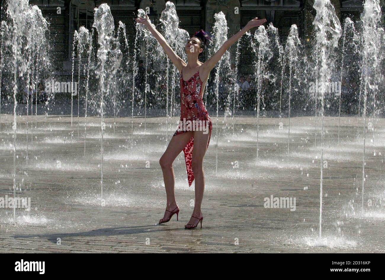 British supermodel, Erin O'Connor, in the fountains on Central Square, Somerset House in London, launching London Fashion Week. Stock Photo