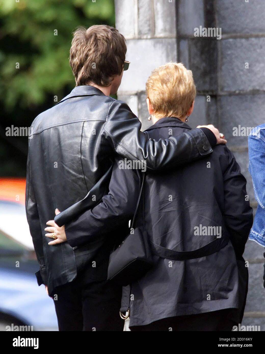 Oasis star Noel Gallagher with a comforting arm around his mother Peggy