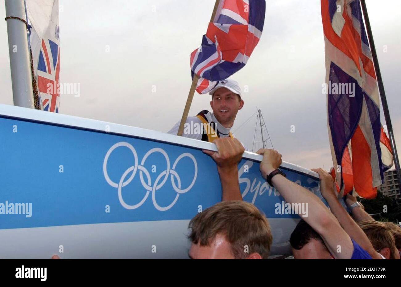 Great Britain's Ben Ainslie celebrates as his boat is carried ashore, following his final race in the Laser Sailing class at the Olympic Games in Rushcutters Bay, Sydney, Australia. He is waiting for the results of a protest after seeming to claim Gold medal.  * The 23 year old started the final race of the series nine points adrift of Brazilian Robert Scheidt. However, a brave and cunning piece of seamanship saw Ainslie pin the Brazilian at the back of the fleet, insuring Scheidt's previously discarded high fleet positions were brought back into the results summary. Stock Photo