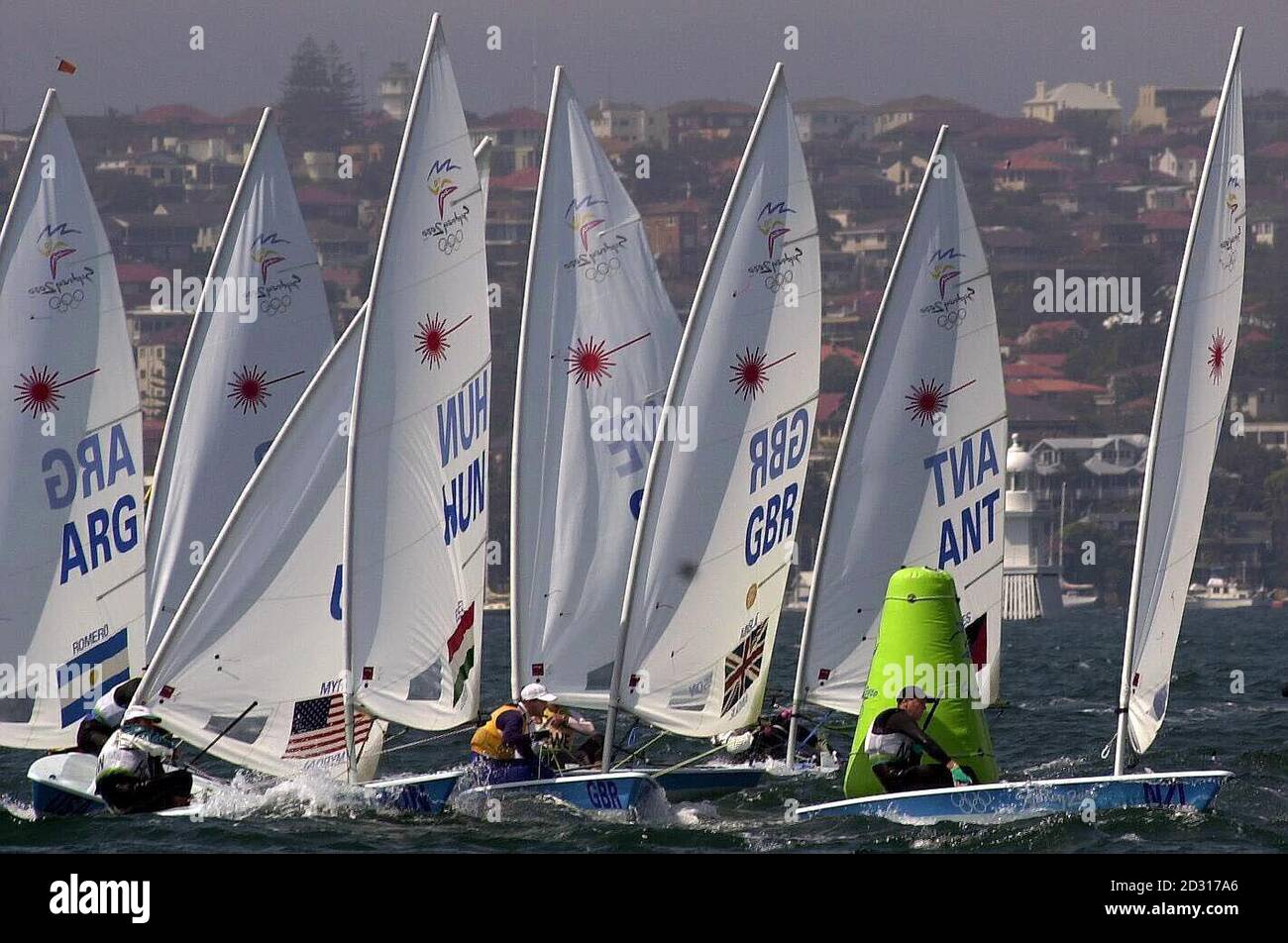Great Britain's Ben Ainslie (centre) in action during his final race in the Laser Sailing class at the Olympic Games in Rushcutters Bay, Sydney. Ainslie will have to wait on the results of a protest after seeming to claim the Gold medal.   *  The 23 year old started the final race of the series nine points adrift of Brazilian Robert Scheidt. However, a brave and cunning piece of seamanship saw Ainslie pin the Brazilian at the back of the fleet, insuring Scheidt's previously discarded high fleet positions were brought back into the results summary. Stock Photo