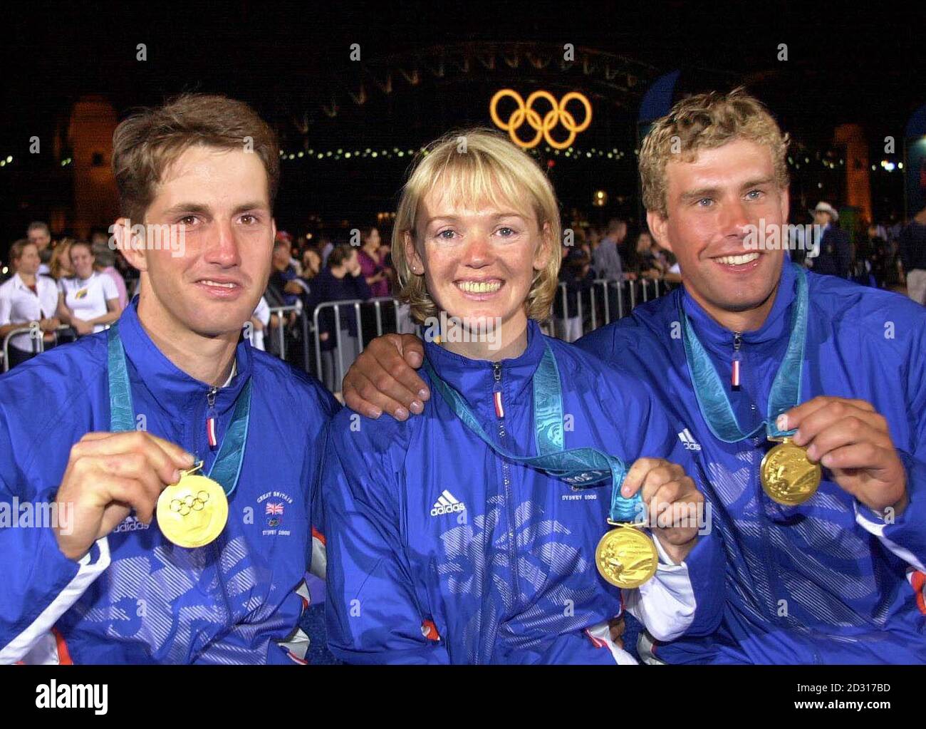 Great Britain's Sailing Gold medallists (L-R) Ben Ainslie, Shirley Robertson and Iain Percy celebrate their Olympic Games success in front of the Harbour Bridge, Sydney, Australia. * Ainslie won the Gold medal in the Men's Laser Class, Robertson in the Women's Europe Class and Percy in the Men's Finn Class. Stock Photo