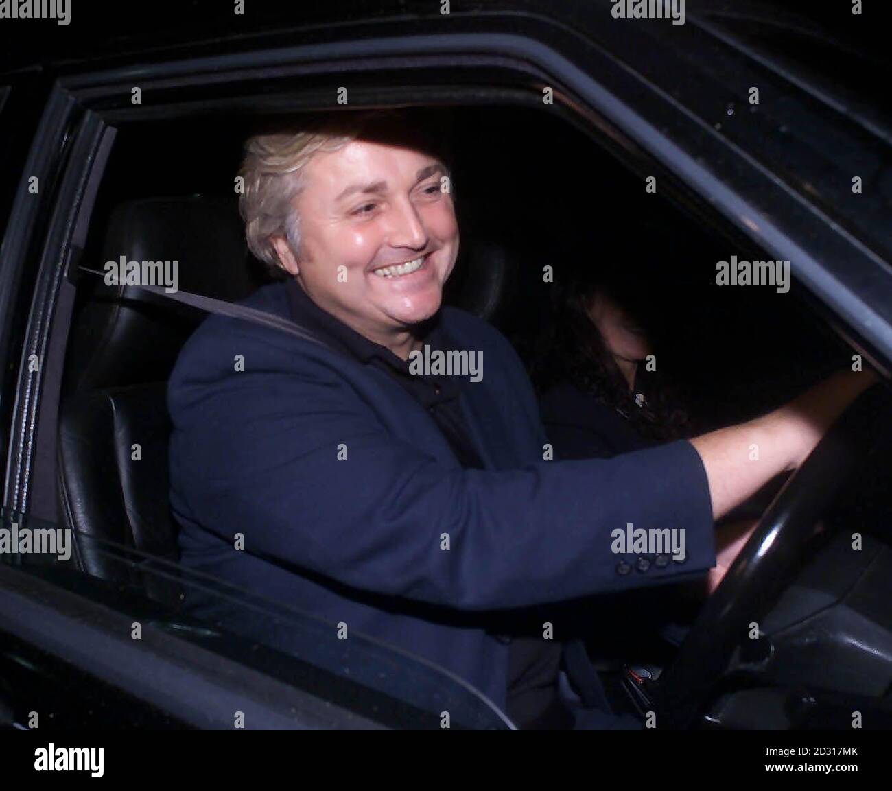 Fashion designer David Emanuel drives away from the Marriott Hotel, in Swansea, in his car after a meeting with actress Catherine Zeta Jones. Stock Photo