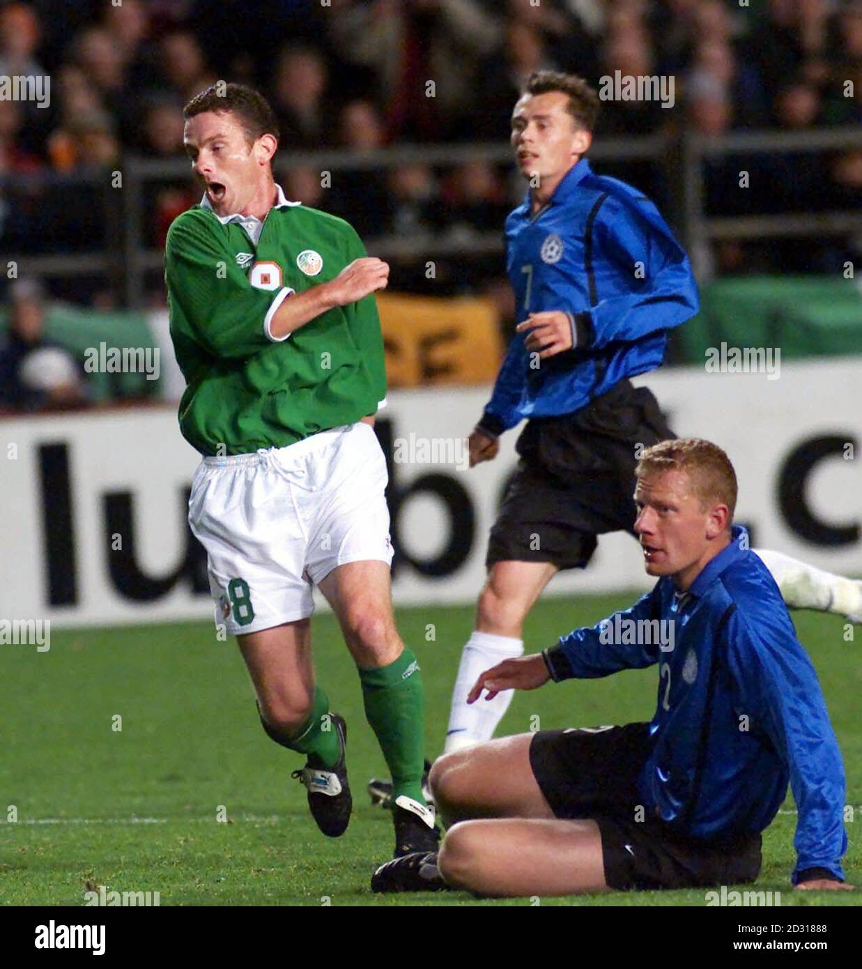 Estonia's Marek Lamslau (on ground) and Sergei Terehhov can only watch as Mark Kinsella scores for the Republic of Ireland during their World Cup Qualifying match at Lansdowne Road, Dublin. Stock Photo