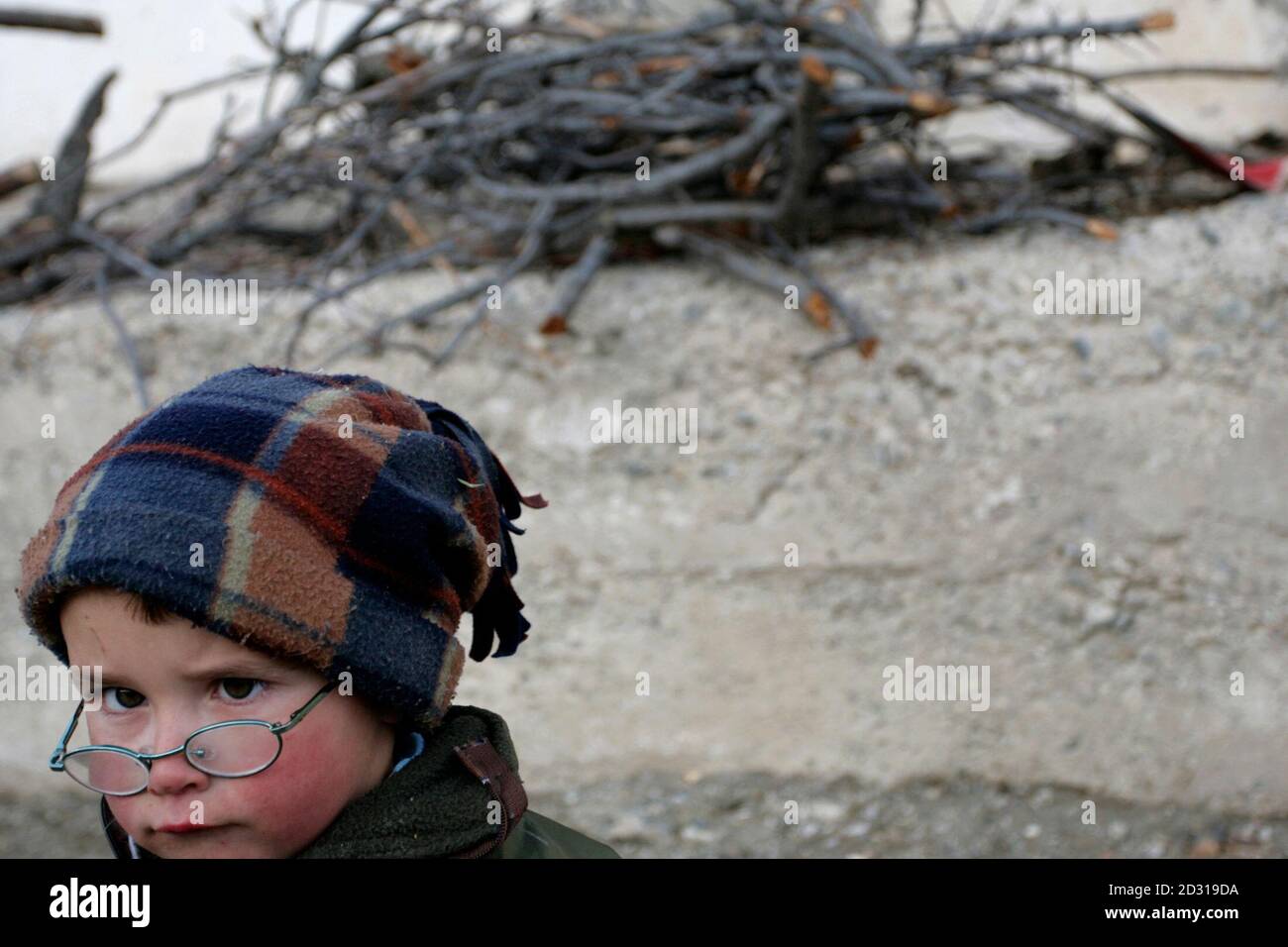An ethnic Gorani child stands in the village of Brod in the Sharr mountain region of southern Kosovo February 10, 2008. A slow exodus threatens the existence of the Sharr region's Muslim Slavs, known as Gorani, as Kosovo's ethnic Albanian majority prepares to declare independence from Serbia. The Gorani minority shares the Islamic faith of Kosovo Albanians, but the Slav identity and language of their Serb former rulers. Picture taken February 10, 2008. REUTERS/Matt Robinson (SERBIA) Stock Photo