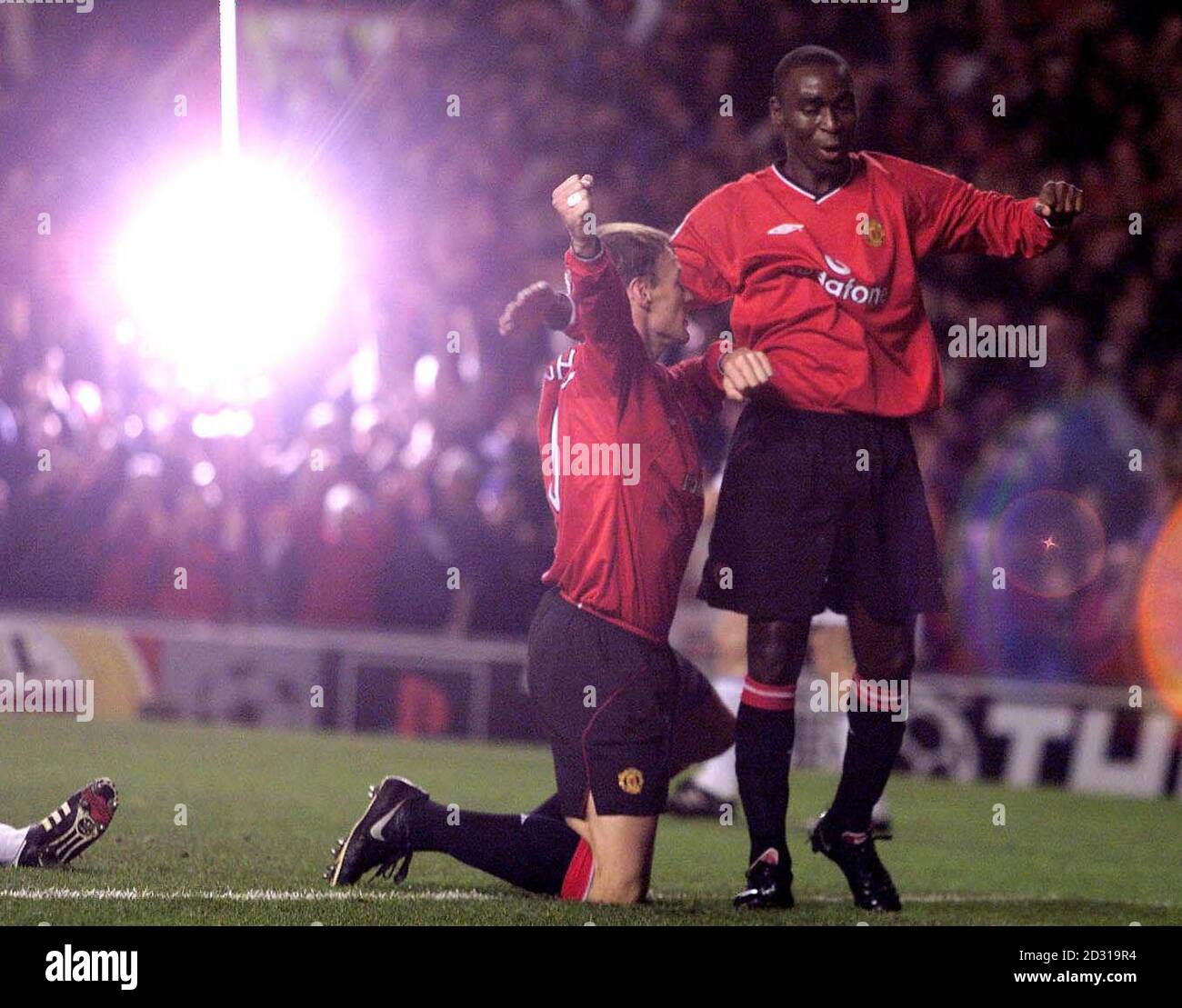 A glow of light for Manchester United's Teddy Sheringham as he celebrates his goal against Dynamo Kiev at Old Trafford during their Champions League match. Stock Photo