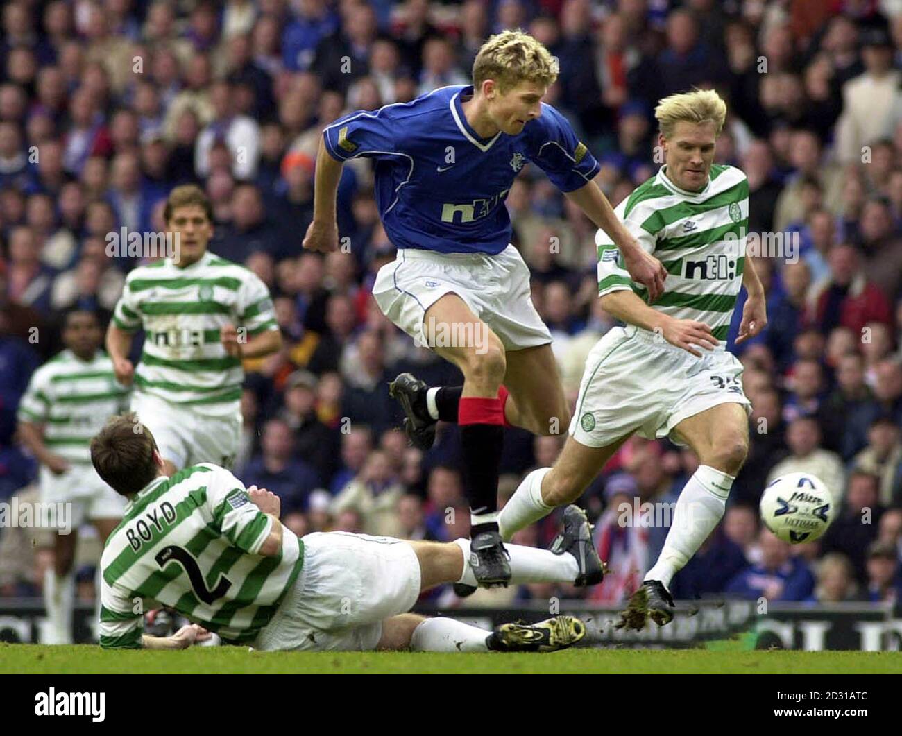 Rangers new signing Tore Andre Flo jumps past Celtic's Tom Boyd and Johan Mjallby during their Scottish Premier League match at Ibrox Stadium. Final Score: Rangers 5 Celtic 1. Stock Photo