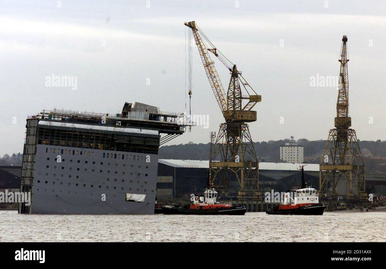 Workers at the Cammel Laird shipbuilders in Merseyside launch the new 26,000-tonne section for the Italian cruise liner Costa Classica.  Blustery gales had forced the company to delay the launch. Stock Photo