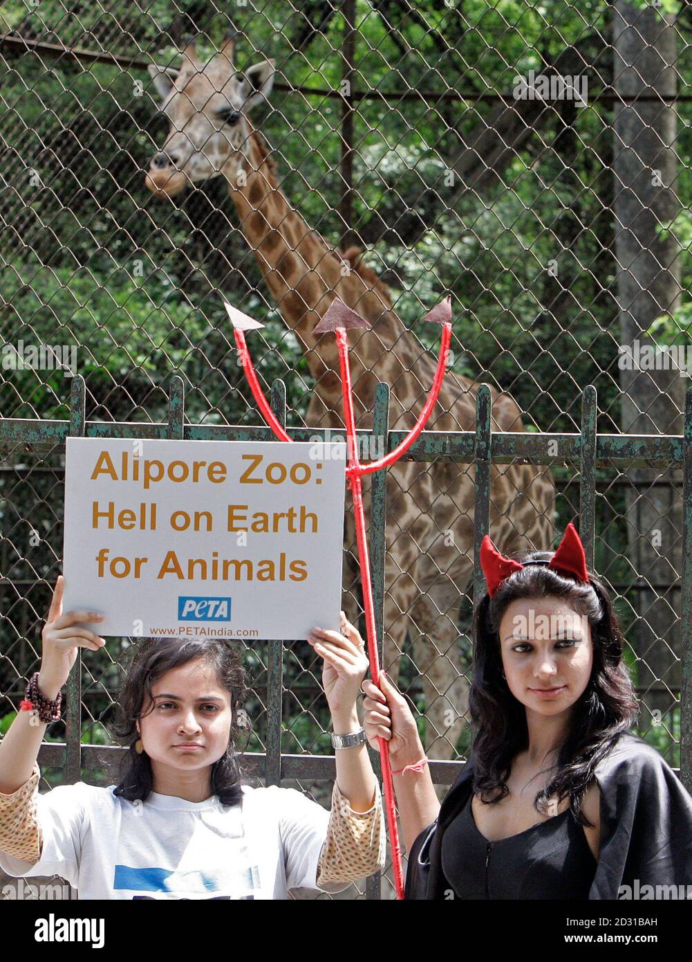 Activists from People for the Ethical Treatment of Animals (PETA) attend a  protest in front of a giraffe enclosure at the Alipore zoo in the eastern  city of Kolkata May 28, 2008.