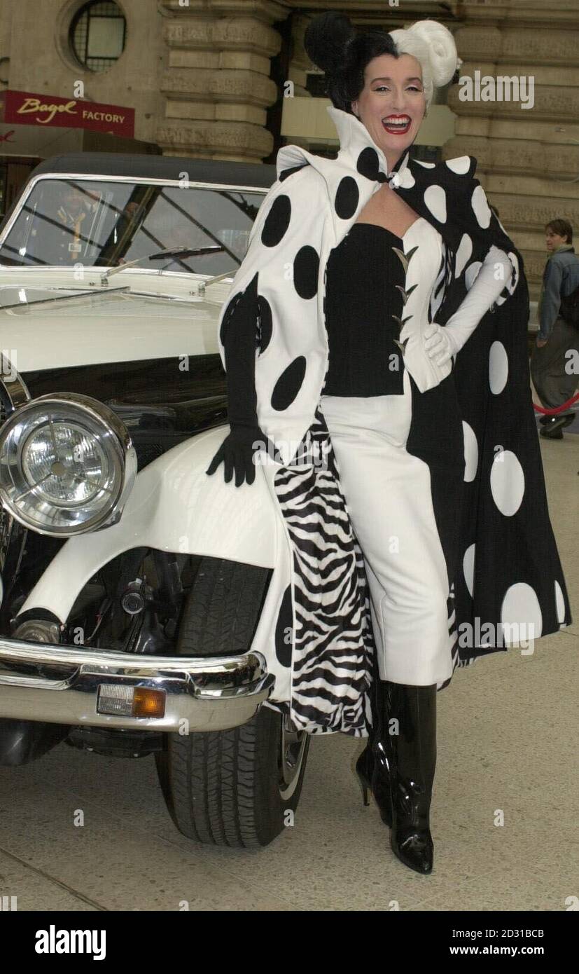 Film character Cruella DeVil arrives at Waterloo Station in London to launch Disney's '102 Dalmatians' Eurostar train. All eighteen coaches of the quarter mile train are covered in images of dalmatian puppies. Stock Photo