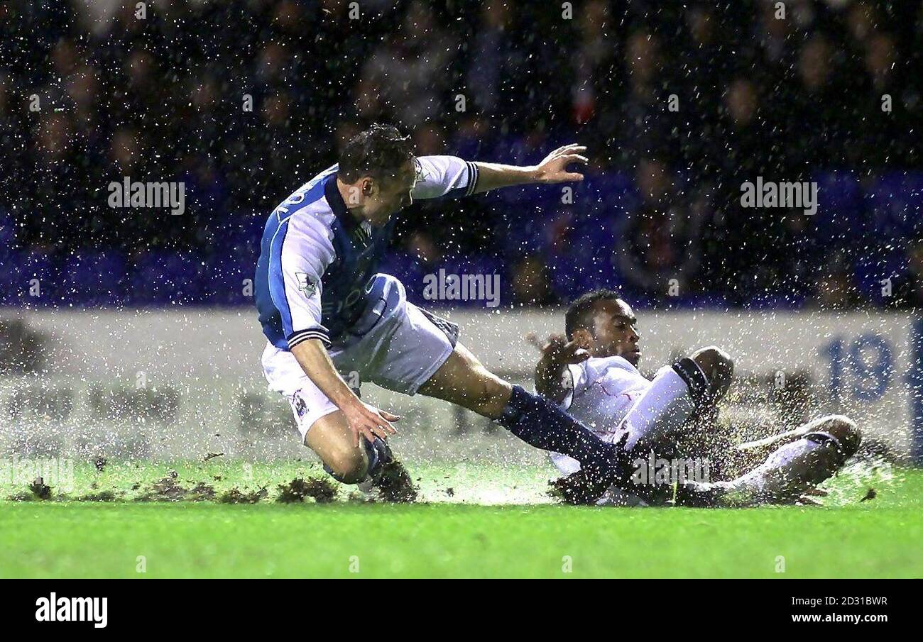 Manchester City's Paul Dickov (left) slides in to tackle Ipswich's Fabian Willness, during their Worthington Cup football match at Maine Road. The match was abandoned due to rain, during the second half with the scores at 1-1. THIS PICTURE CAN ONLY BE USED WITHIN THE CONTEXT OF AN EDITORIAL FEATURE. NO WEBSITE/INTERNET USE UNLESS SITE IS REGISTERED WITH FOOTBALL ASSOCIATION PREMIER LEAGUE. Stock Photo