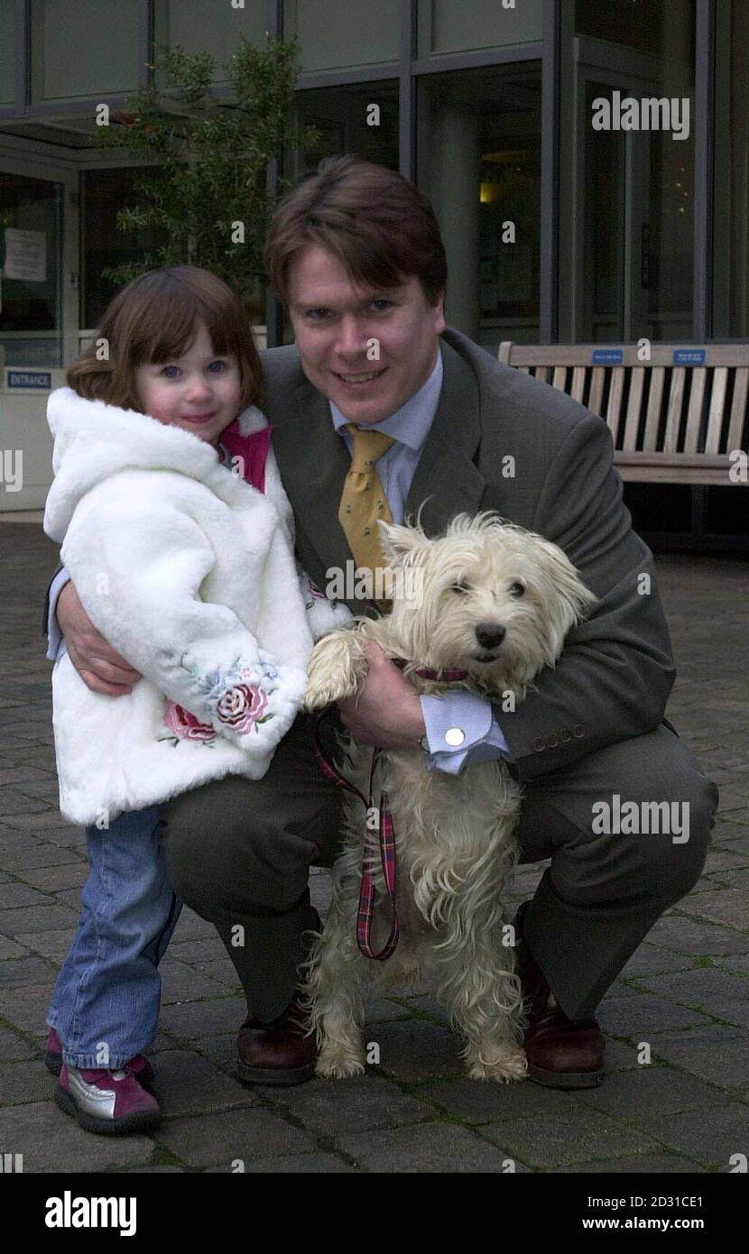 Barrington Hooke and his daughter Jemima, three, are reunited with their West Highland White Terrier Sally at Battersea Dogs' Home, in London. Sally escaped from the family home in Rotherhithe on Christmas Day and was bought to Battersea on Boxing Day. Stock Photo