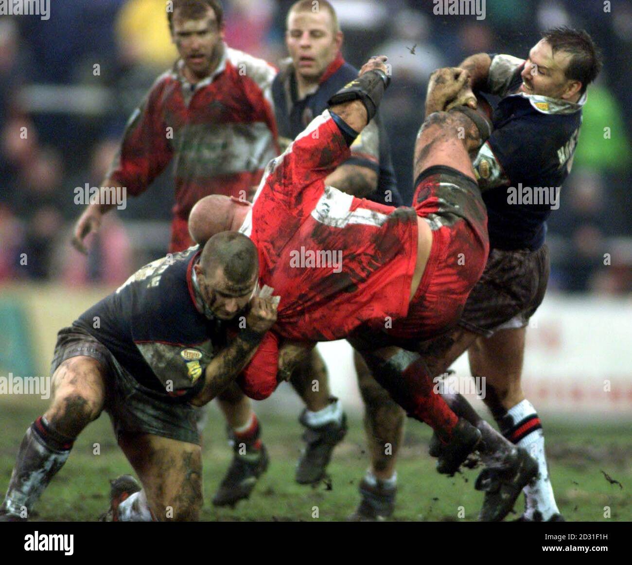 Leigh's Dave Whittle (centre) is tackled by Salford's Paul Southern and Michael Hancock during the Silk Cut Challenge Cup fourth round game at Hilton Park, Leigh. Stock Photo