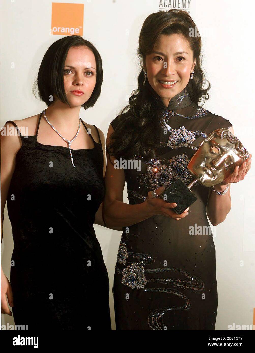 Actress Christina Ricci (left) and actress Michelle Yeoh with one of the four awards won by Crouching Tiger, Hidden Dragon, during The Orange British Academy Film Awards at the Odeon in London's Leicester Square.   *   The ceremony has been brought forward several weeks from previous years to give it a more prominent position in the film calendar. Stock Photo