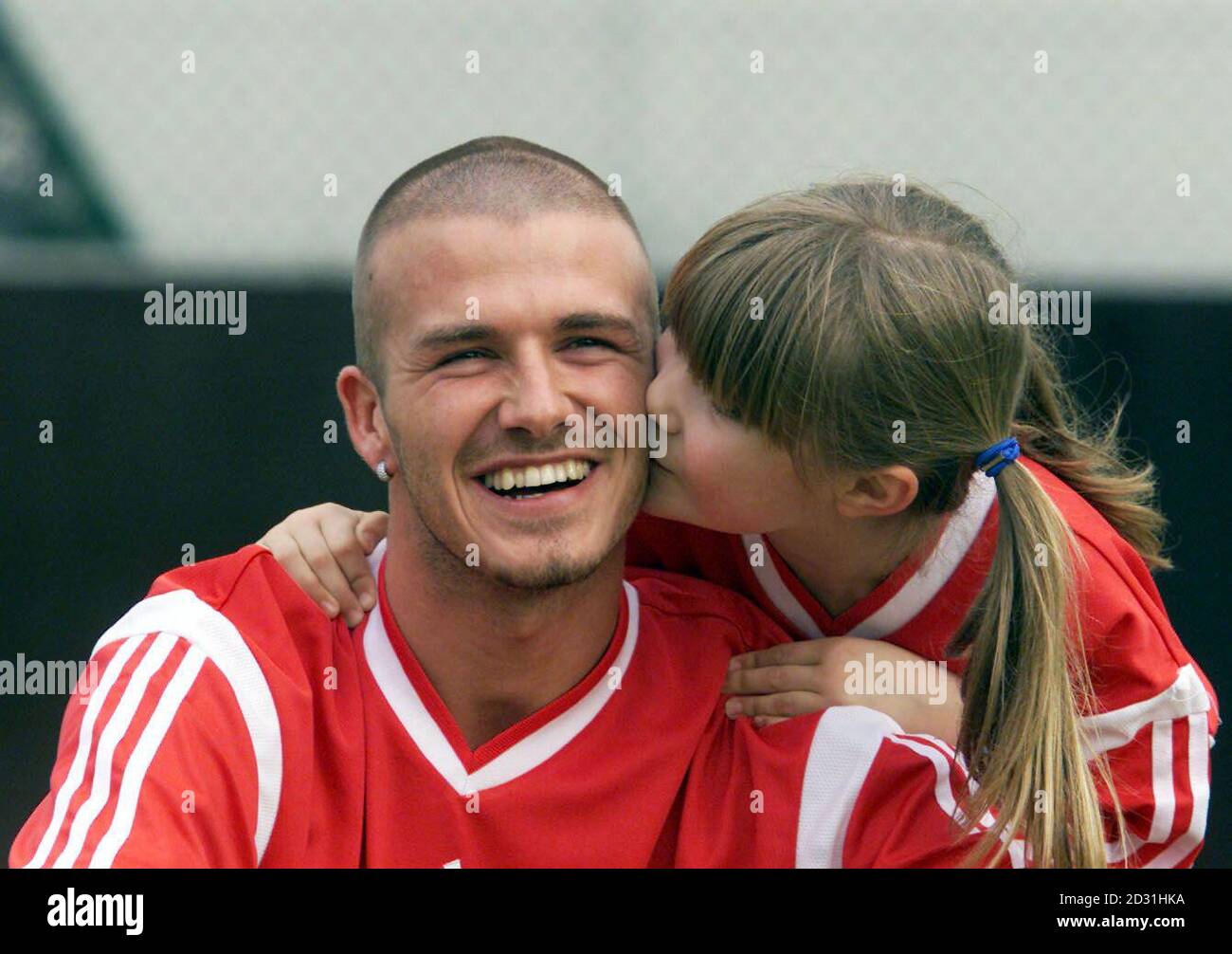 Manchester United and 'Adidias Ambassador' David Beckham gets a kiss from  Georginia Tuck aged 8 from Macclesfield, at the launch of a schools football  initiative at Adidas' Stockport base. The scheme has