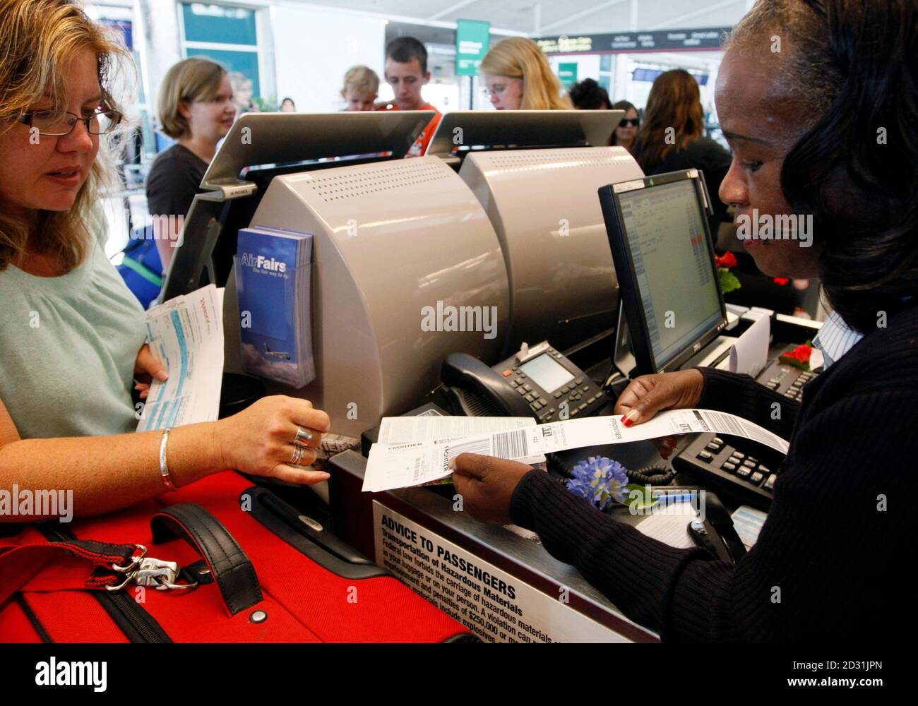Frontier Airlines Customer Service Agent Marilyn Brooks Helps A Passenger At The Ticket Counter At The Denver Airport August 27 2009 Frontier Was Acquired By Republic Airways In An August 14 Auction