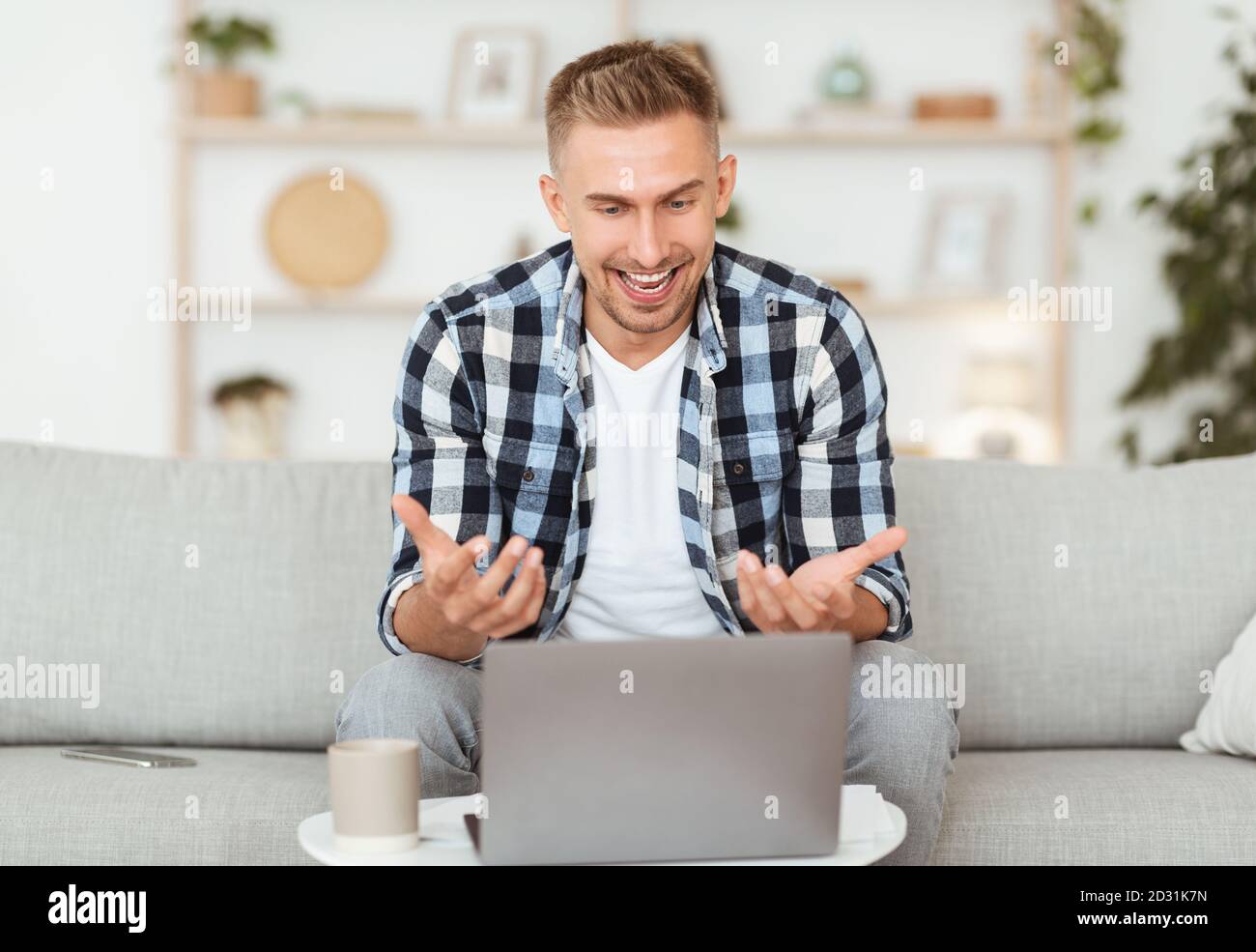 Happy man using laptop for video call and talking Stock Photo