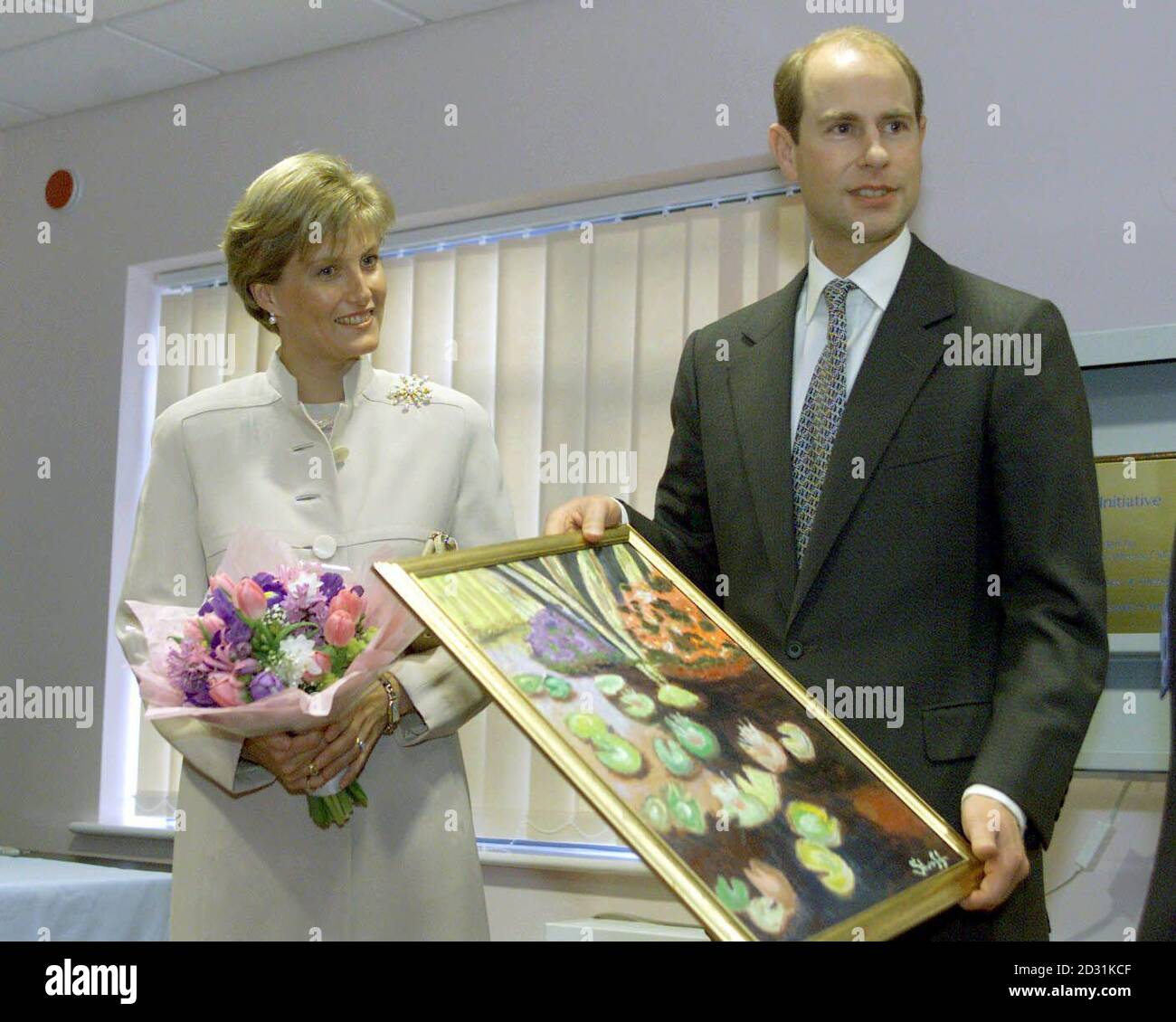 The Count And Countess of Wessex with gifts presented to them during their visit toThe Disability Initiative Resource Centre in Camberley, Surrey. * The Countess was presented with flowers by 21-year-old Terry Parish, who has lost both of her legs below her knee and all her fingertips due to illness, and the still life painting came from a patient called David Shevloff, who had spent three months working on the gift. Stock Photo