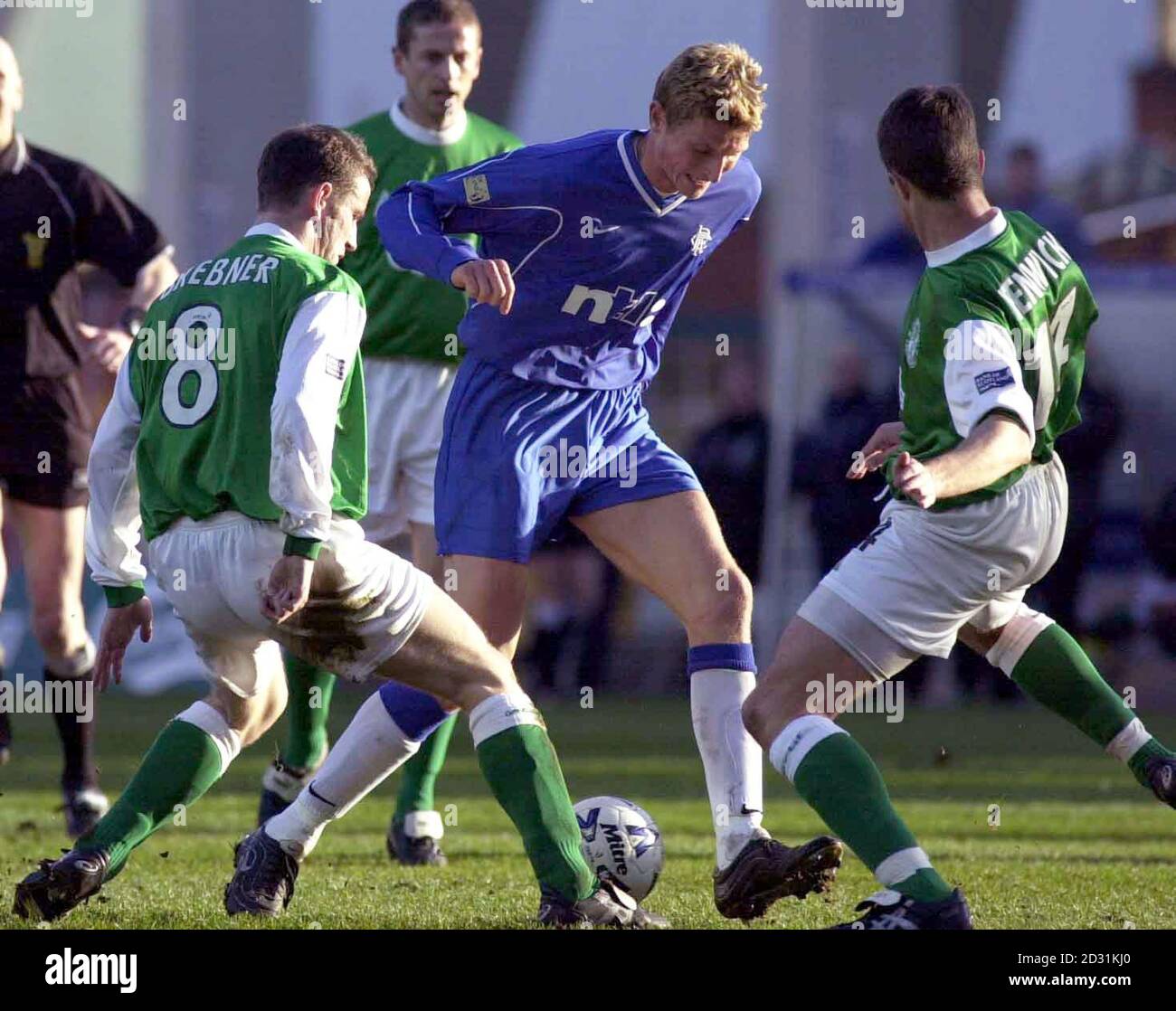 Rangers Tore Andre Flo (centre) holds off Hibernian's Grant Brebner (left) and Paul Fenwick during the Bank of Scotland Premier game at Easter Road, Edinburgh. Stock Photo