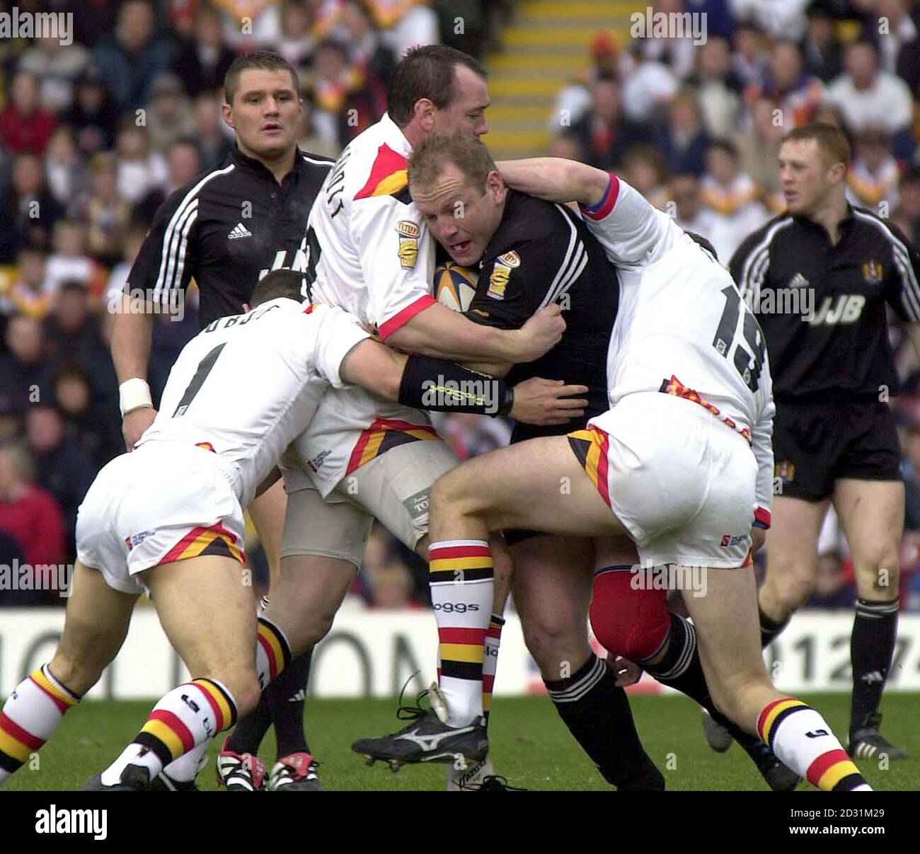 Wigan Warriors' Terry O'Connor (centre) is tackled by Bradford Bulls Brian McDermott (2nd left), during their Tetley's Bitter Super League Rugby league game at Valley Parade, in Bradford. Stock Photo