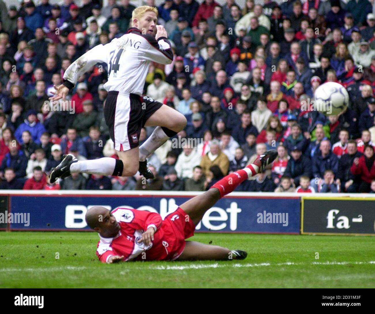 THIS PICTURE CAN ONLY BE USED WITHIN THE CONTEXT OF AN EDITORIAL FEATURE. NO WEBSITE/INTERNET USE UNLESS SITE IS REGISTERED WITH FOOTBALL ASSOCIATION PREMIER LEAGUE.  Ipswich Town's Alun Armstrong (top) lifts the ball over Middlesbrough's Ugo Ehioug to score his second against Middlesbrough, during the Premiership football match at The Riverside Stadium, Middlesbrough. Stock Photo