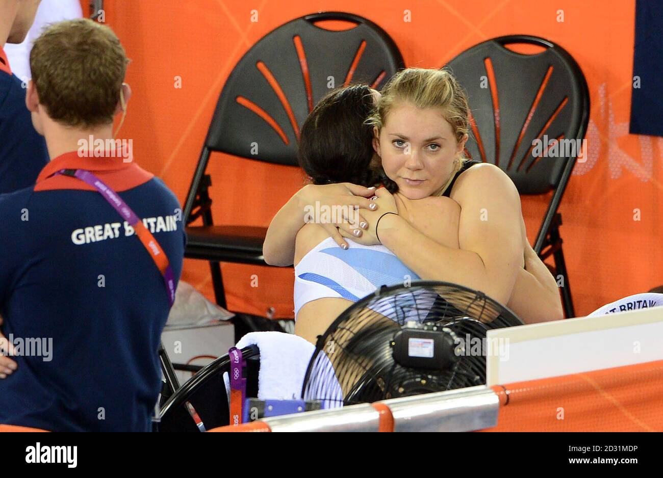 Great Britain's Jess Varnish hugs Victoria Pendleton after they were relegated from the team sprint first round on the first day of the track cycling at the Velodrome in the Olympic Park. Stock Photo