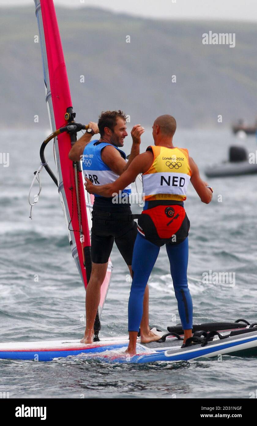 Great Britain's Nick Dempsey (left) celebrates winning his silver medal with the Netherland's Dorian Van Rijsselberge who won gold in the Men's RS:X class at the Olympics on Weymouth Bay. Stock Photo