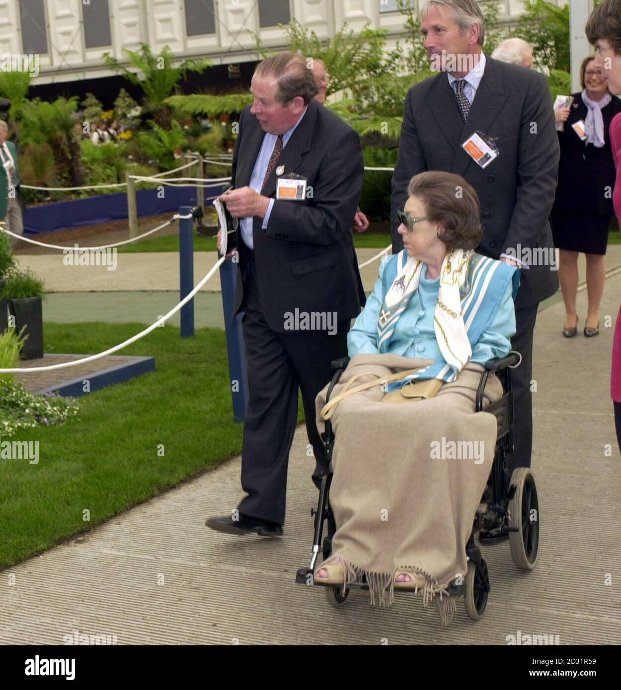 Princess Margaret, looking frail after a series of strokes, being pushed around at the Chelsea Flower Show in a wheelchair. The Queen's 70-year-old sister arrived at a side gate while other members of the Royal Family were welcomed at the main entrance. *... of the world-famous flower show. It was the first time Margaret had been seen in public since she left hospital in January after suffering her second stroke which affected her left side. Since then, she has been hit by a third stroke which impaired her vision. Determined not to miss the London flower show, Margaret wore dark glasses and Stock Photo