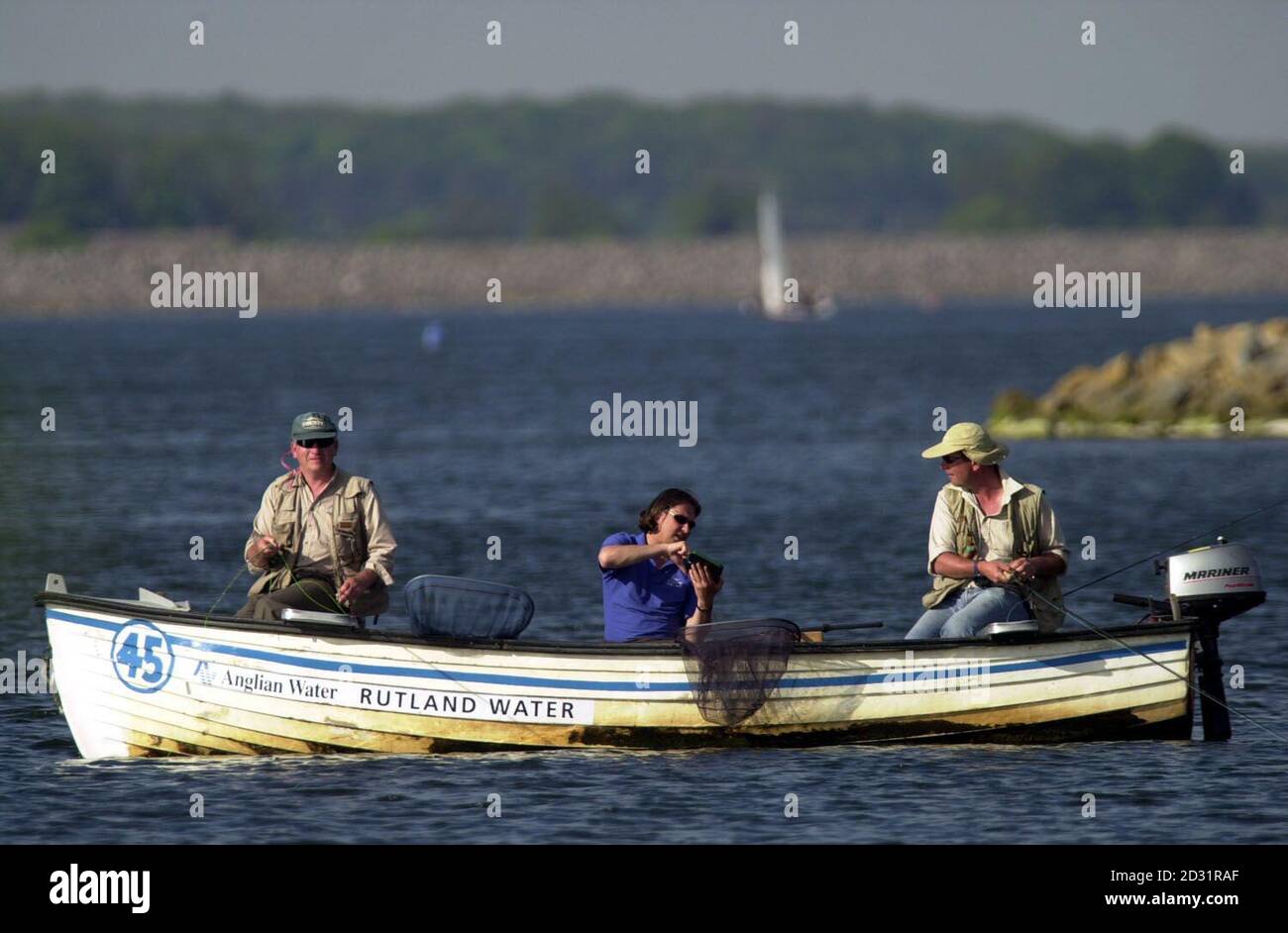 Three men take advantage of the recent warm weather at Rutland water. Stock Photo