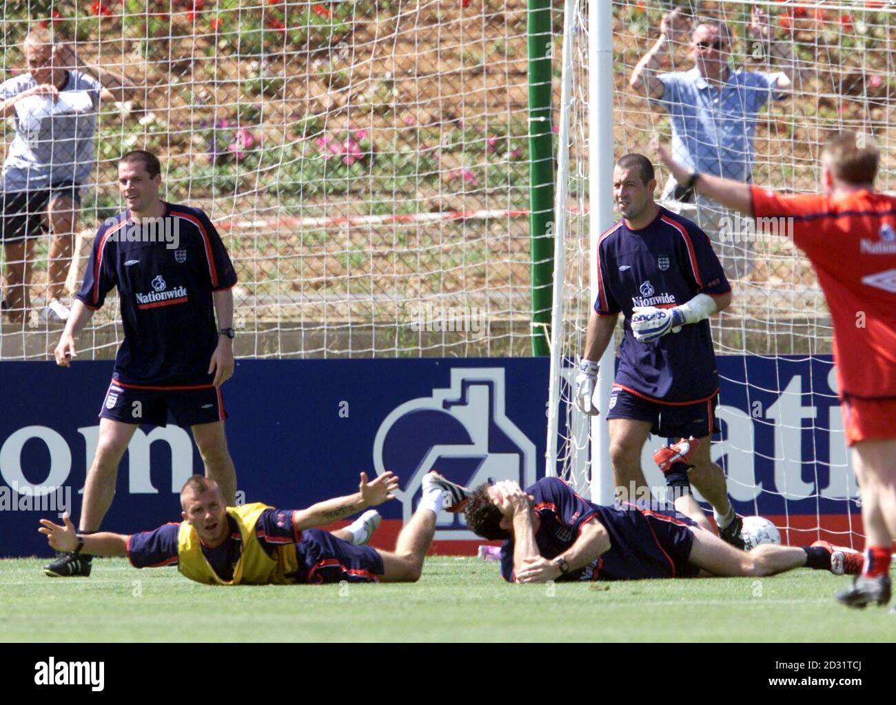 England's David Beckham (second left on floor) looks at coach Sammy Lee (far right) after a fun clash with Martin Keown (right floor holding his face) during a training session in Murcia, La Manga, Sunday 3rd June 2001, prior to England's World Cup European Qualifying game against Greece next Wednesday. Stock Photo