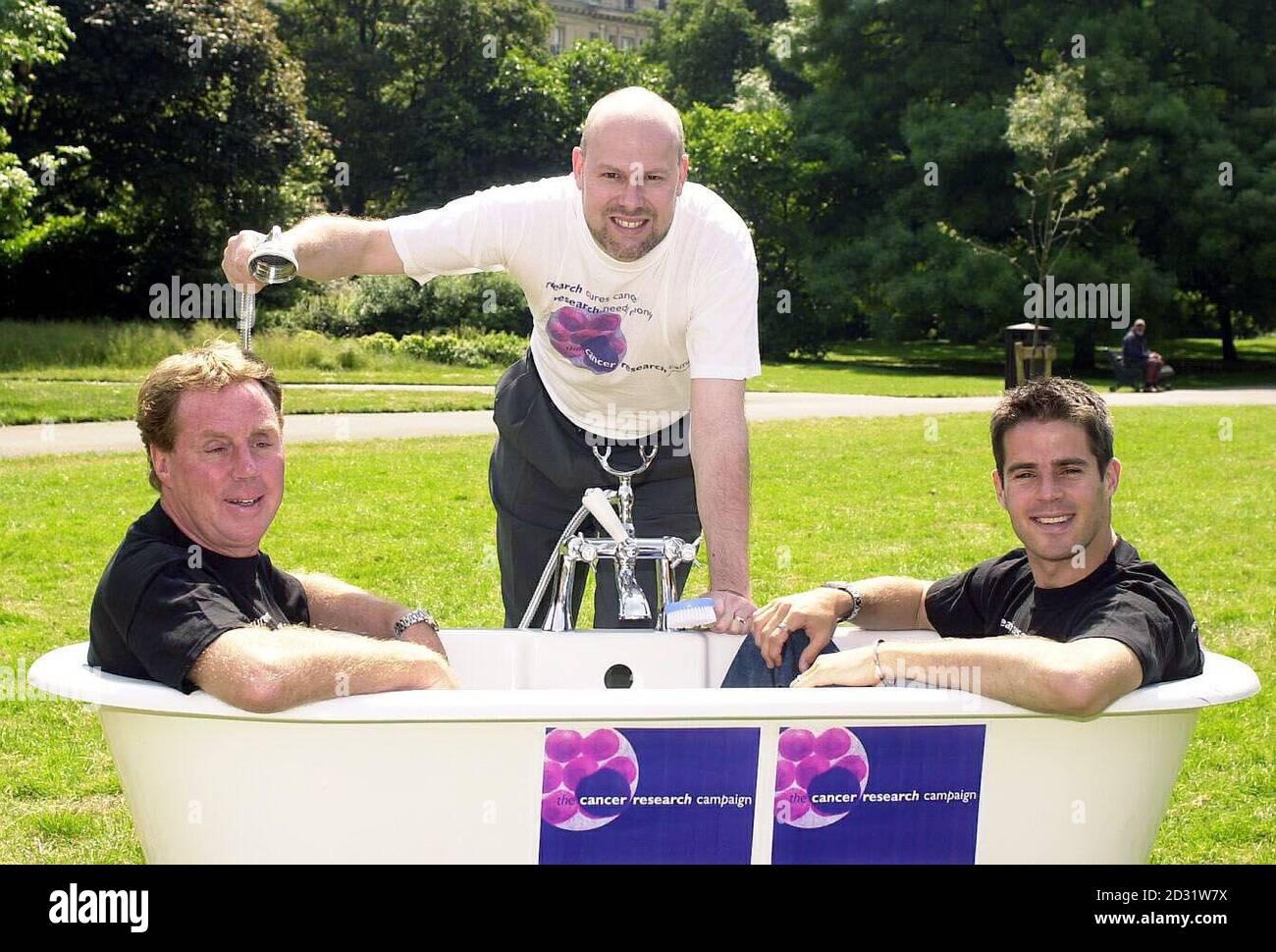 Testicular Cancer survivor David Brown, 39, (C) from Kingston Upon Thames helps Liverpool captain Jamie Redknapp (R) and his father, former West Ham manager Harry, have a shower in Regent's Park, London, to help highlight Men's Cancer Awareness month.  Stock Photo