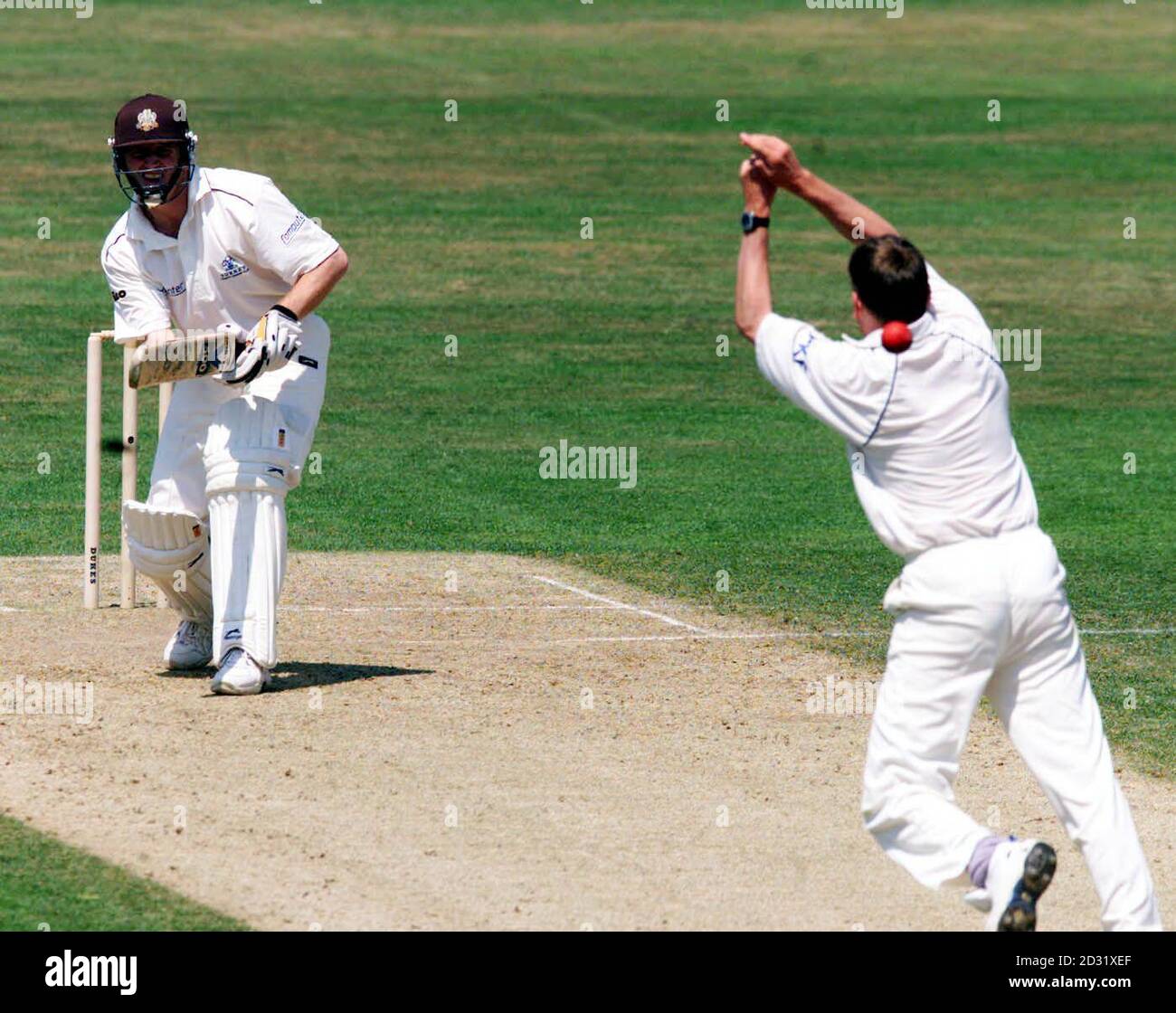 Surrey batsman Alistair Brown chips the ball over the hands of ...