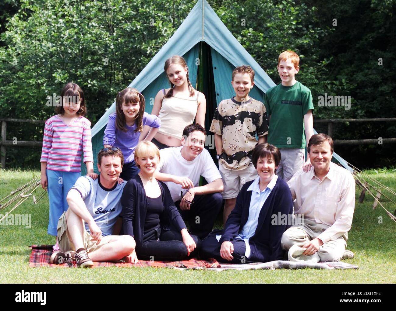 The Coronation Street cast during filming of a camping special, which are entirely set on location in the Chesire countryside. The episodes will be screened on July 23rd, 27th and 30th 2001. * (Back left-right) Sophie Webster played by actress Emma Woodward, Rosie Webster played by Helen Flanagan, Sarah Louise Platt,Tina O'Brien her younger character brother David Platt, Jack P Shepherd and Wayne played by Gary Damer. (Front Left -right) Martin Platt, played by Sean Wilson, Sally Webster played by actress Sally Whittaker, Todd Grimshaw played by Bruno Langley, Hayley, Julie Hesmondhalgh an Stock Photo