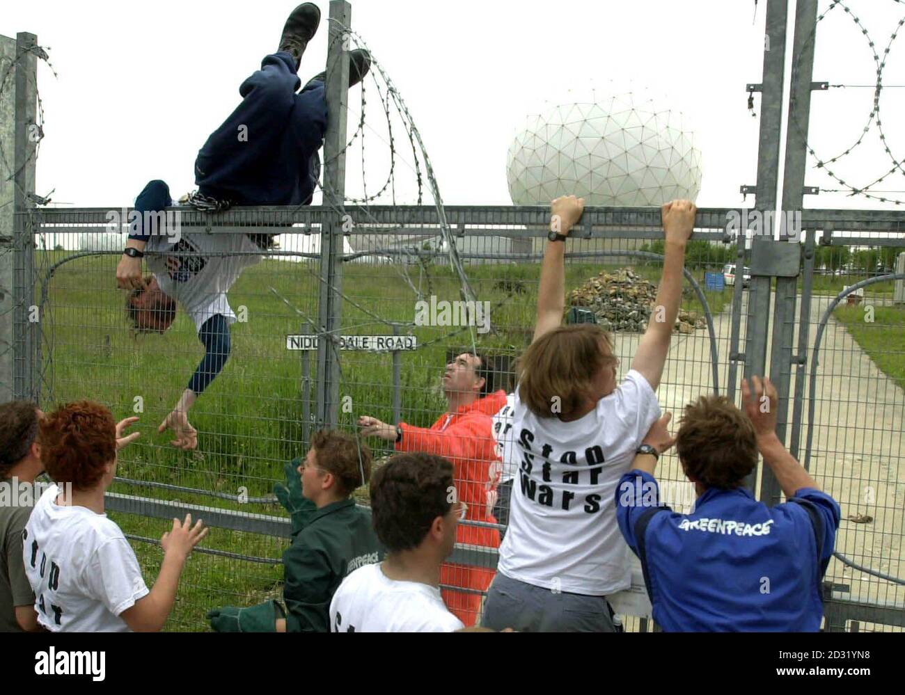 Some of more than 100 peace protesters who broke into major British defence site Menwith Hill Base, near Harrogate, scaling the perimeter fence. Greenpeace said its activists entered the spy base to protest against US plans to use it as part of its Son of Star Wars. * ...national missile defence programme. North Yorkshire Police confirmed they were attending an incident at the base but said they could give no further details. Greenpeace said three groups of protesters were occupying three areas within the high security site. It claimed one group of 50 activists, some carrying flags with the m Stock Photo