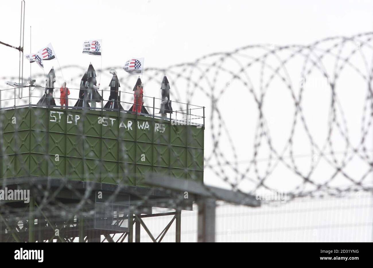 Some of more than 100 peace protesters who broke into major British defence site Menwith Hill Base, near Harrogate, occupying the Water Tower inside base. Greenpeace said its activists entered the spy base to protest against US plans. * ...to use it as part of its Son of Star Wars national missile defence programme. North Yorkshire Police confirmed they were attending an incident at the base but said they could give no further details. Greenpeace said three groups of protesters were occupying three areas within the high security site. It claimed one group of 50 activists, some carrying flags Stock Photo