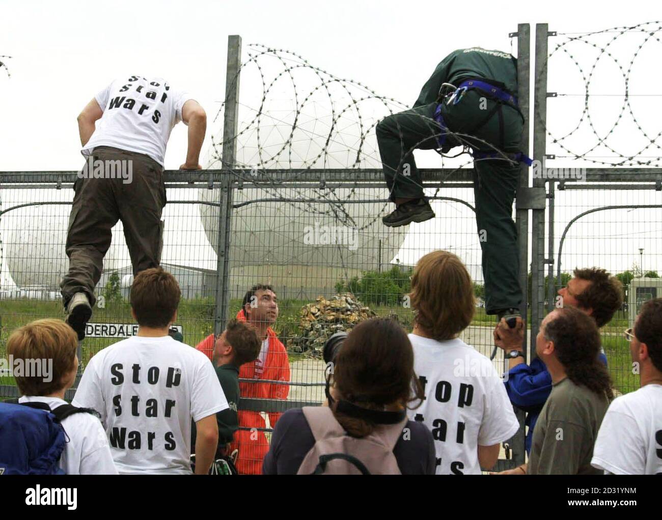 Some of more than 100 peace protesters who broke into major British defence site Menwith Hill Base, near Harrogate, scaling the perimeter fence. Greenpeace said its activists entered the spy base to protest against US plans to use it as part of its Son of Star Wars. * ...national missile defence programme. North Yorkshire Police confirmed they were attending an incident at the base but said they could give no further details. Greenpeace said three groups of protesters were occupying three areas within the high security site. It claimed one group of 50 activists, some carrying flags with the Stock Photo