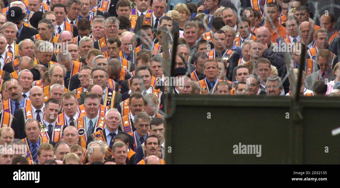 Grim faces on Orange Order Members and supporters are halted at a barrier erected by the security forces. They were prevented from marching from their Church Service at Drumcree along the Nationalist Garvaghy Road in Portadown, Ulster. Stock Photo