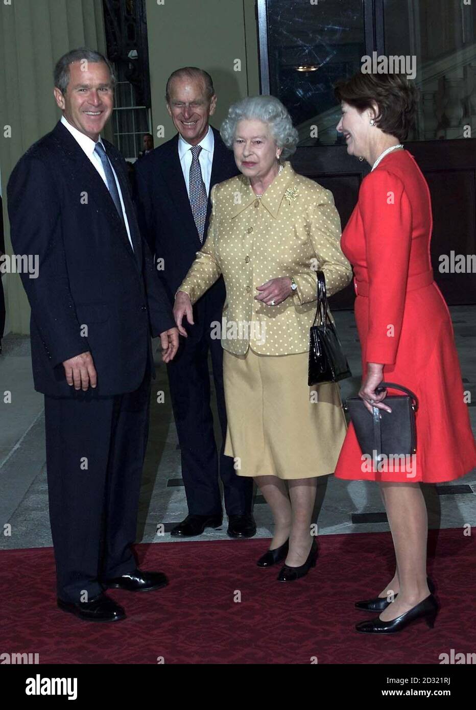 America's President Bush (left) is greeted by Britain's Queen Elizabeth II and the Duke of Edinbugh as he arrives out of the rain with his wife, Laura, at Buckingham Palace for lunch.    * The US president is on his first visit to the United Kingdom, before travelling on to the G8 summit in Genoa. Stock Photo