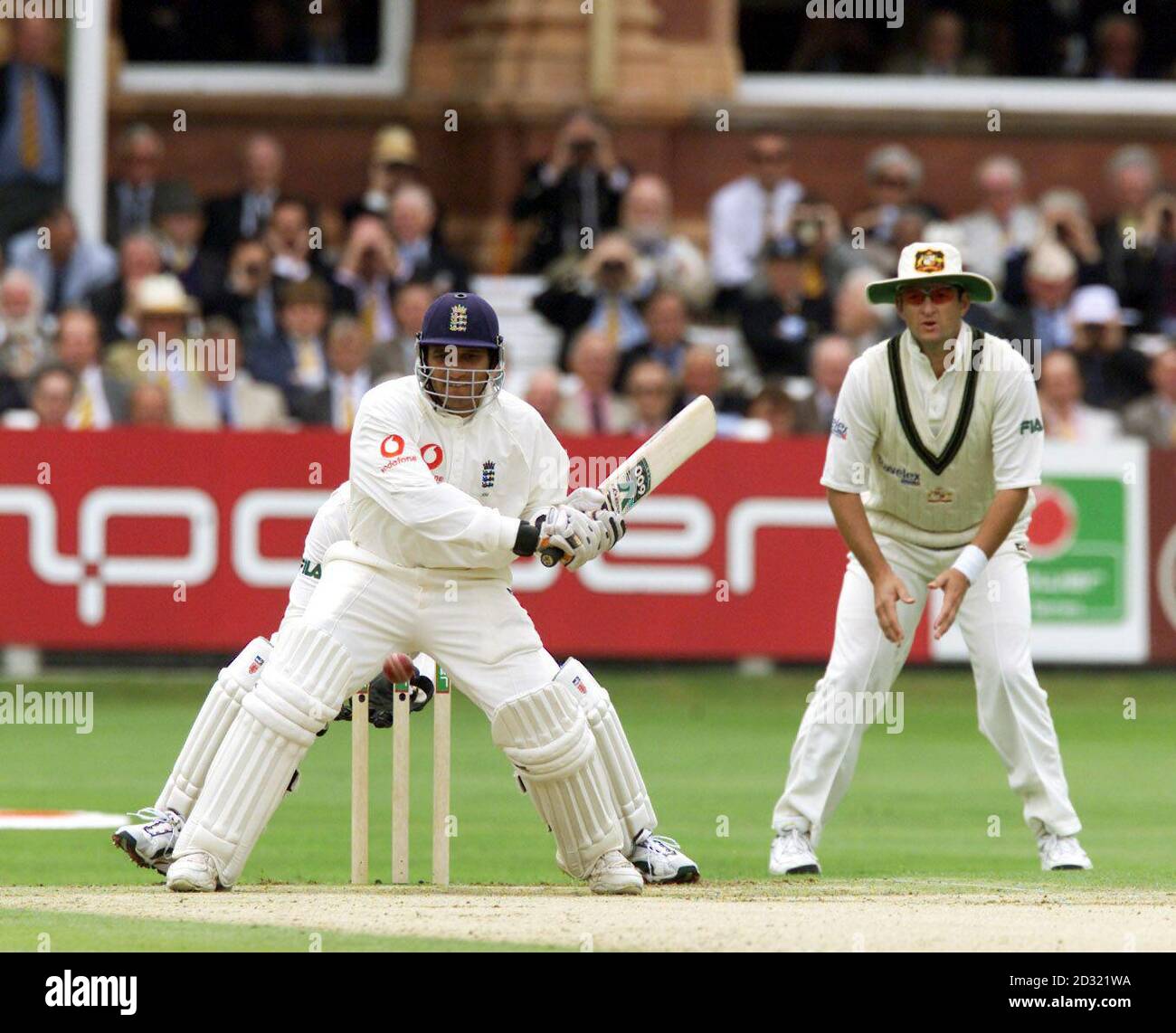England's Mark Butcher (left) hits a boundary off the bowling of ...