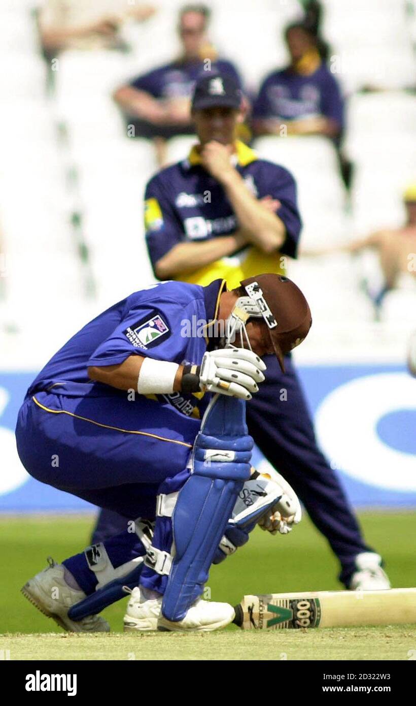 Surrey Lions' Mark Butcher crouches down after being hit on the helmet off the bowling of Warwickshire Bears' Neil Carter during the Norwich Union Division One game at Edgbaston, Birmingham. Stock Photo