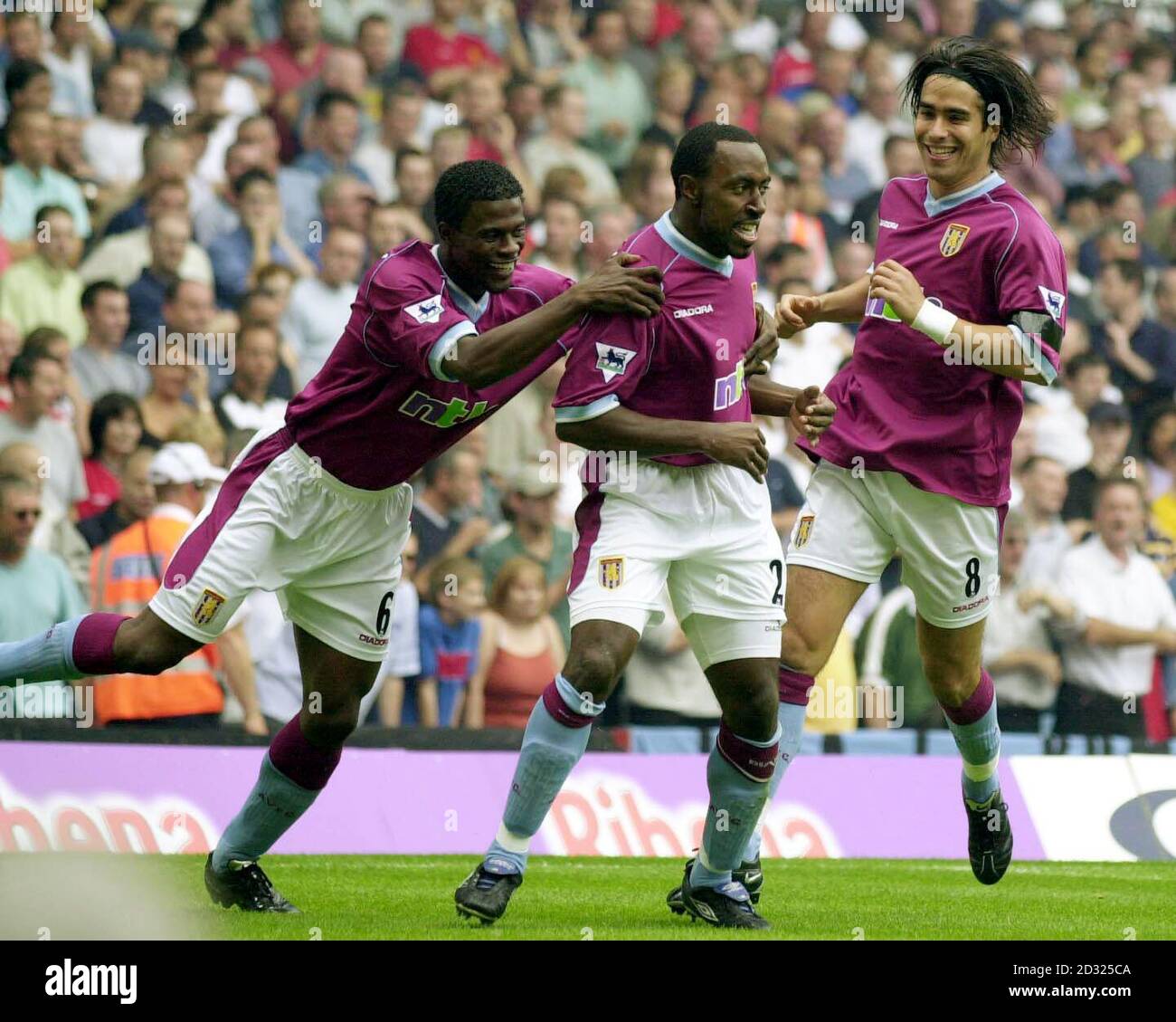 Aston Villa's Darius Vassell celebrates with team-mates George Boateng & Juan Pablo Angel (right) after scoring the first goal against Manchester United during the FA Barclaycard Premiership game at Villa Park, Birmingham. Stock Photo