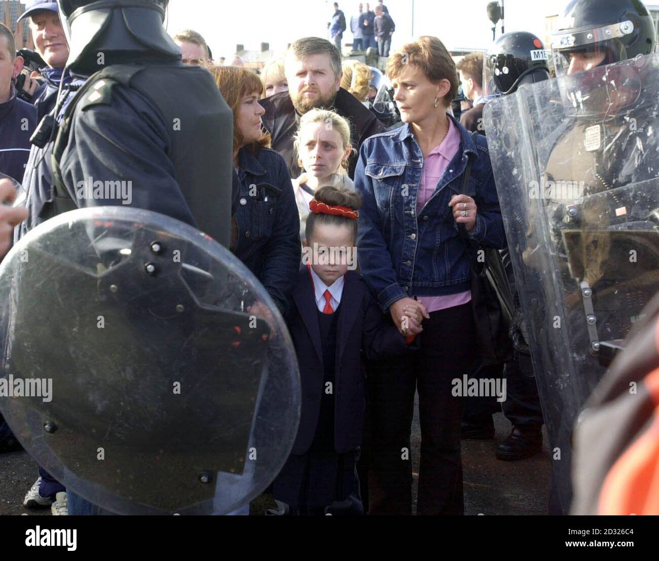 Catholic parents escort their children with RUC Officers in riot gear ...