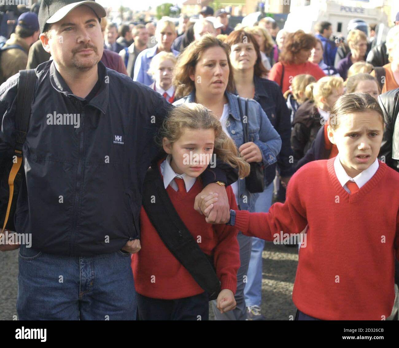 Catholic parents escort their children with RUC Officers in riot gear ...